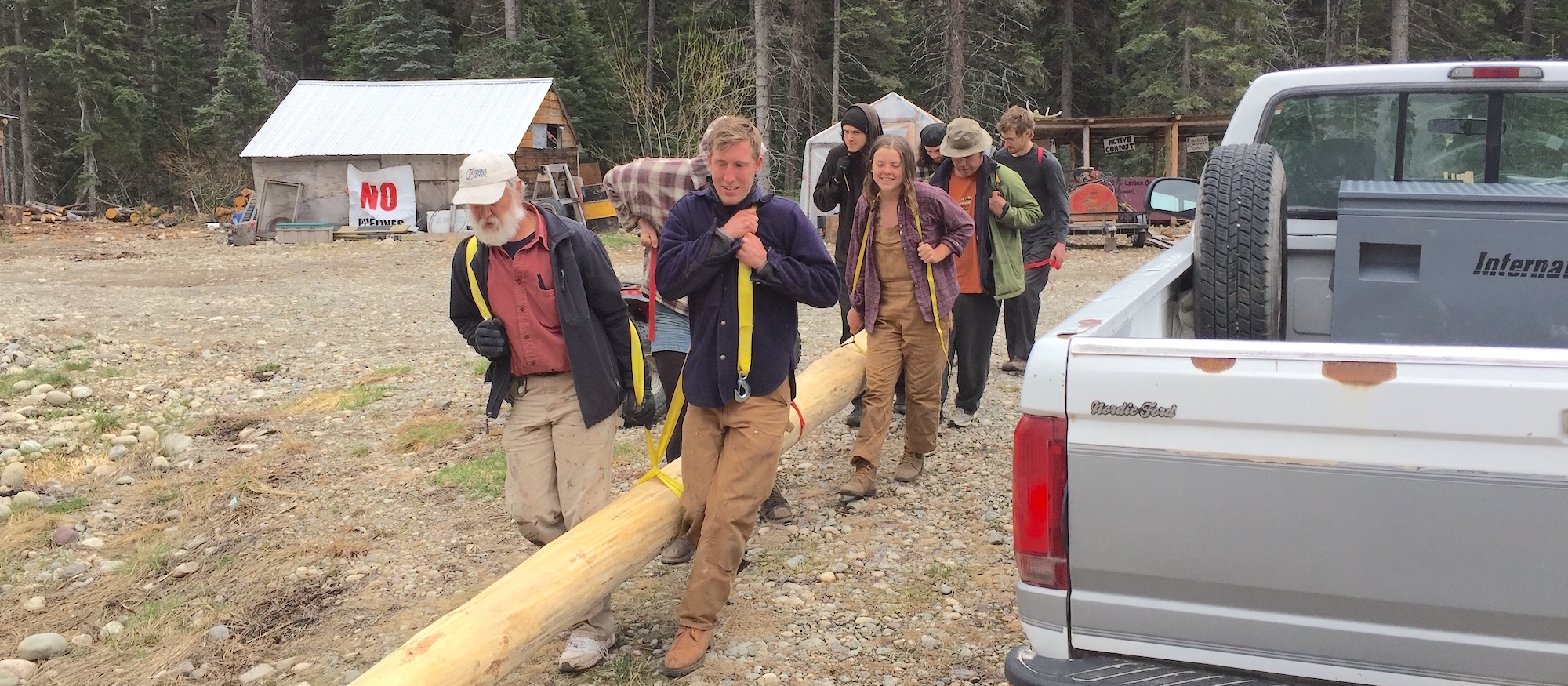 Group of people hawl log